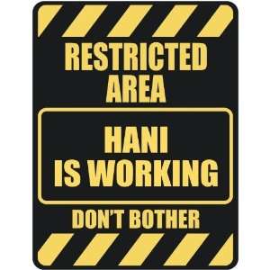 RESTRICTED AREA HANI IS WORKING  PARKING SIGN 