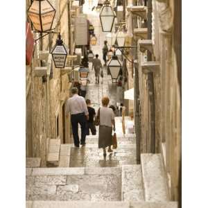 Pedestrians walk down stairs in narrow street, Dubrovnik, Dalmatia 