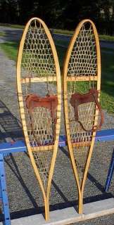 lot of snowshoes toboggans skis paddles and oars listed with a wide 