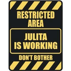   RESTRICTED AREA JULITA IS WORKING  PARKING SIGN