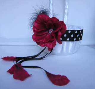   , BLACK FEATHER, RED ROSE AND BLACK RIBBONS WITH RED ROSE PETALS