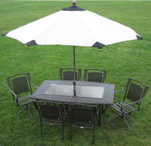 White 9 foot patio umbrella with black accents shades a patio table 
