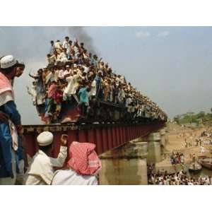  Hundreds of Muslim Pilgrims Ride on a Train Passing on a 