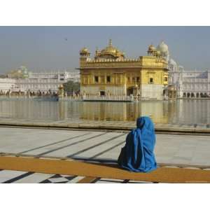 Pilgrim in Blue Sits by the Holy Pool of Nectar at the Golden Temple 