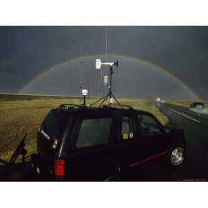  Tornado Chasers Study a Dark Sky with a Perfectly Arched 